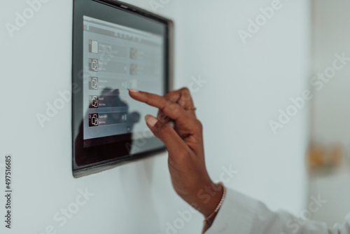 African woman using smart home screen control system