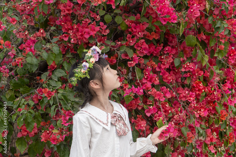 A little girl enjoying flowers in spring A little girl enjoying flowers in spring