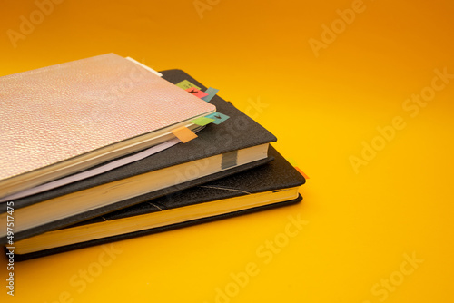Notepad on a bright yellow background, sheets of paper, words on paper