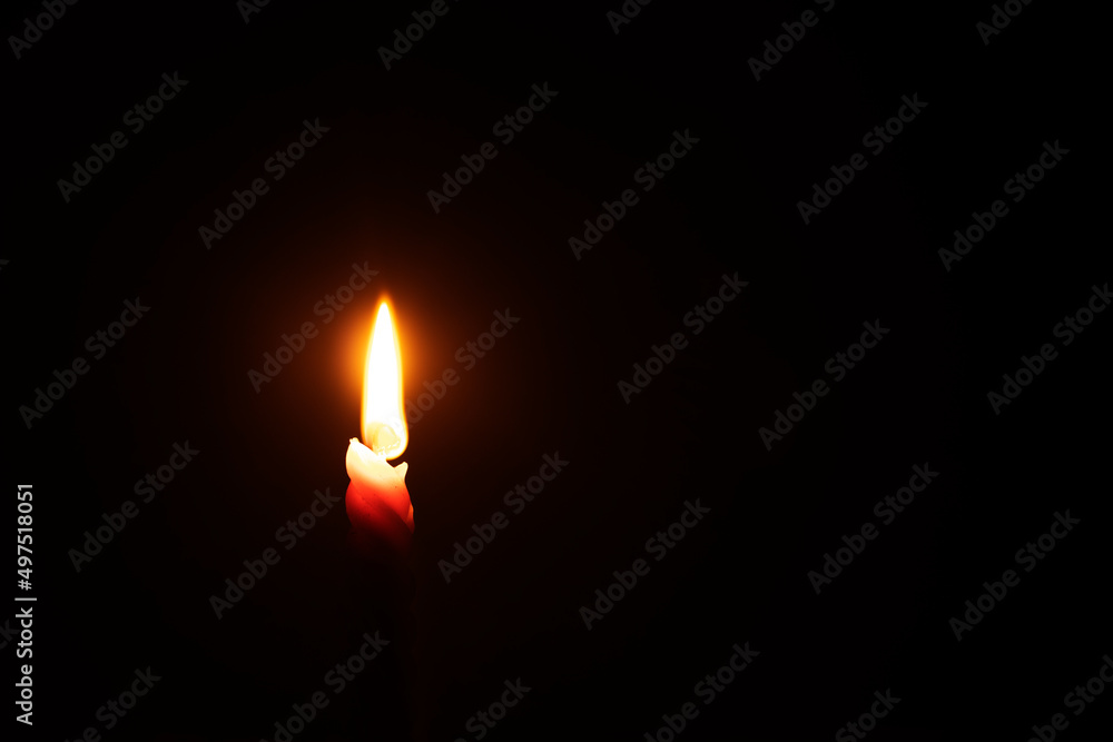 Fototapeta premium light a candle in a dark room