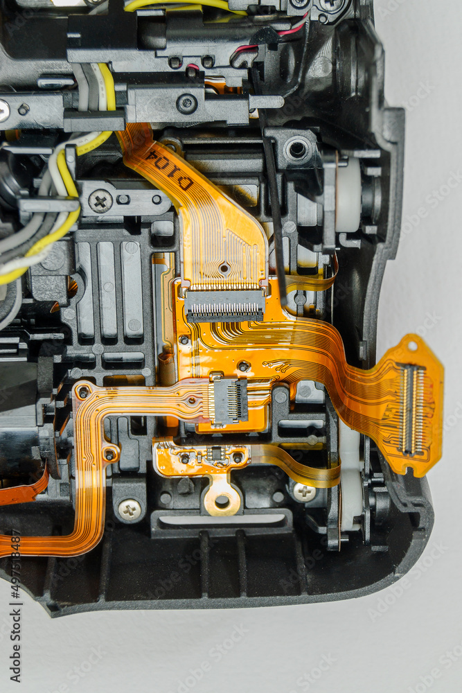 Fototapeta premium Spare parts from a digital camera on a paper background.