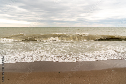 Waves rolling onto the shore of Lake Ontario in spring. Shot in Toronto's iconic Beaches neighbourhood. Room for text 