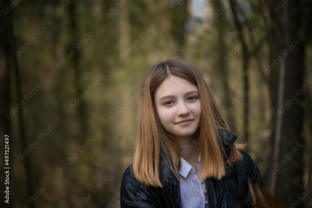 Portrait of a young beautiful fair-haired girl in a summer forest. Portrait of a young beautiful fair-haired girl in a summer forest.