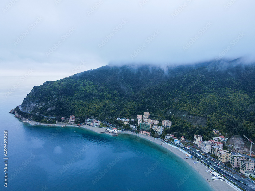 Aerial view of Monte Ursino castle, ancient tower in the old village of Noli on the Ligurian Riviera in north Italy. Drone photography in Liguria, near Noli, Spotorno and Bergeggi.