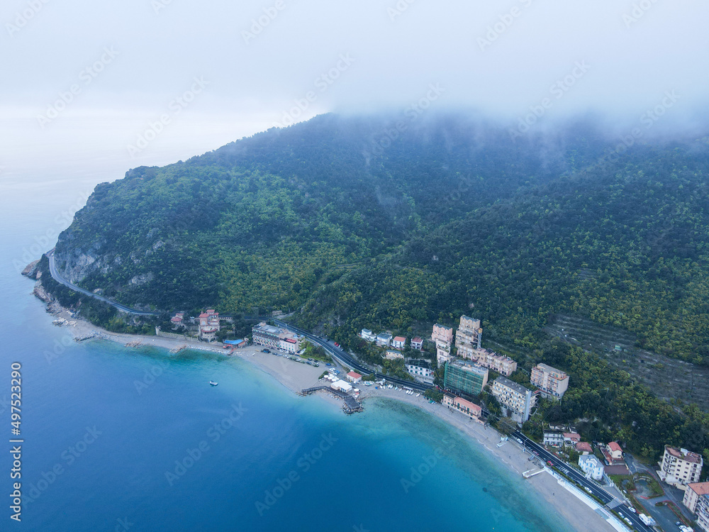 Aerial view of Monte Ursino castle, ancient tower in the old village of Noli on the Ligurian Riviera in north Italy. Drone photography in Liguria, near Noli, Spotorno and Bergeggi.