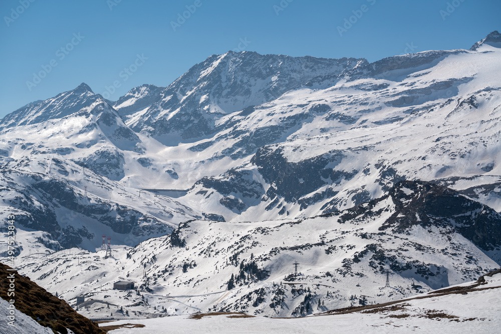 a ski tour in the alps, the hohe tauern national park, with view to a dam at a sunny spring day
