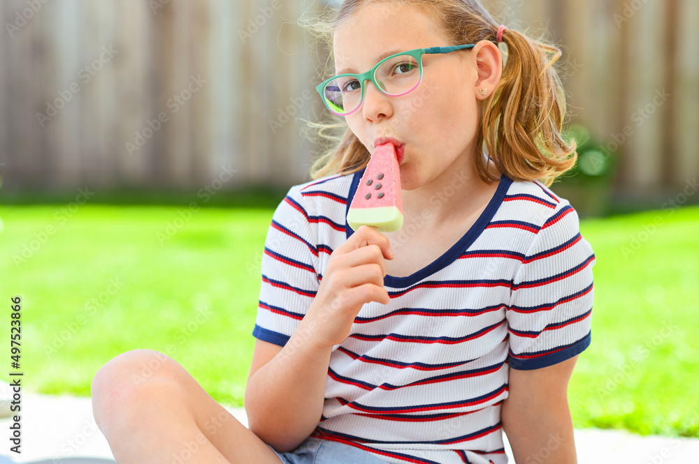 Cute girl eating ice-cream in park Cute girl eating ice-cream in park