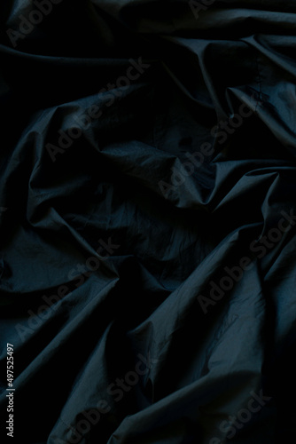 Black wrinkled fabric surface,Close up of wrinkled black color fabric bed sheet texture background