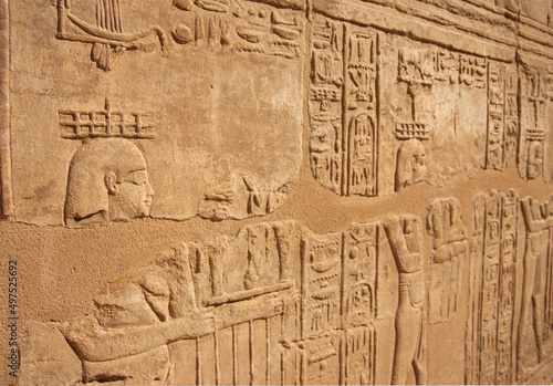 Ancient Egyptian murals hieroglyphs on stone wall in Karnak temple Luxor, Egypt