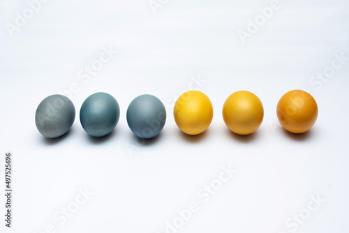 Blue and yellow Easter eggs on a white background for Easter