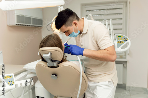 a highly qualified dentist treats the teeth of a young patient. pain free dental treatment. modern dental treatment. dentist examines problem teeth.