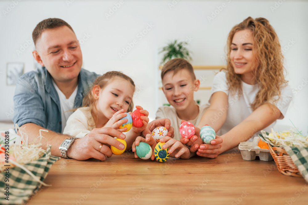 Father, mother, son and daugher. Happy family celebrating Easter holidays together Father, mother, son and daugher. Happy family celebrating Easter holidays together