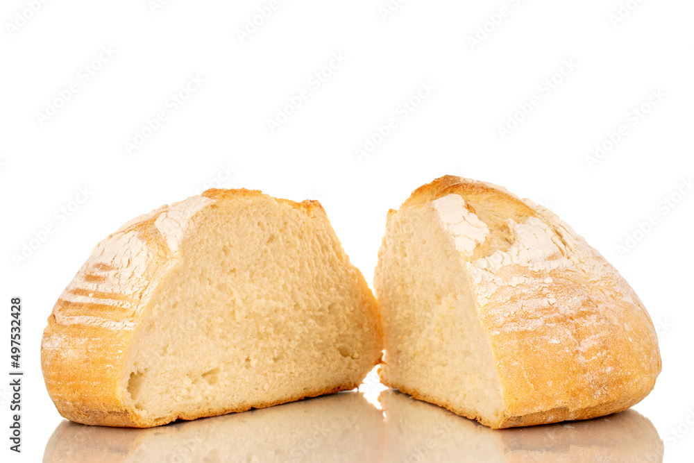 Two halves of a loaf of fresh fragrant white wheat bread, macro, isolated on a white background.