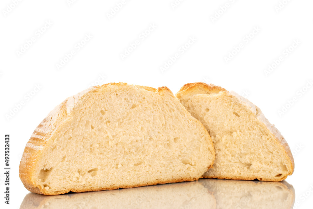 Two halves of a loaf of fresh fragrant white wheat bread, macro, isolated on a white background.