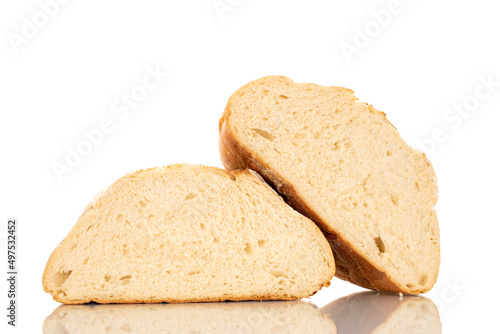 Two halves of a loaf of fresh fragrant white wheat bread, macro, isolated on a white background.