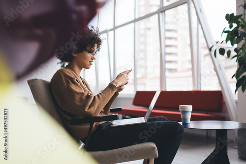 Businesswoman use smartphone and work on laptop © BullRun