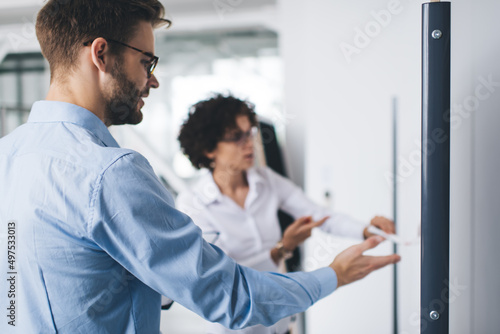 Business man and woman work at interactive board