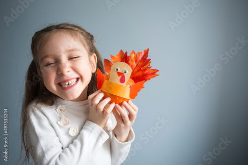 paper craft for kids. DIY Turkey made from pumpkin for thanksgiving day. create art for children. girl playing with toy © Natalia