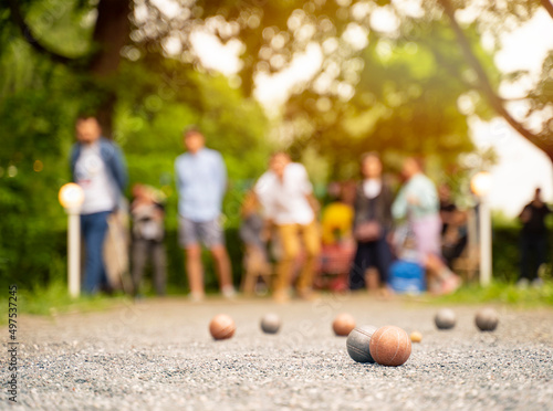 Outdoor active game friends playing petanque guy throwing a ball city park	
