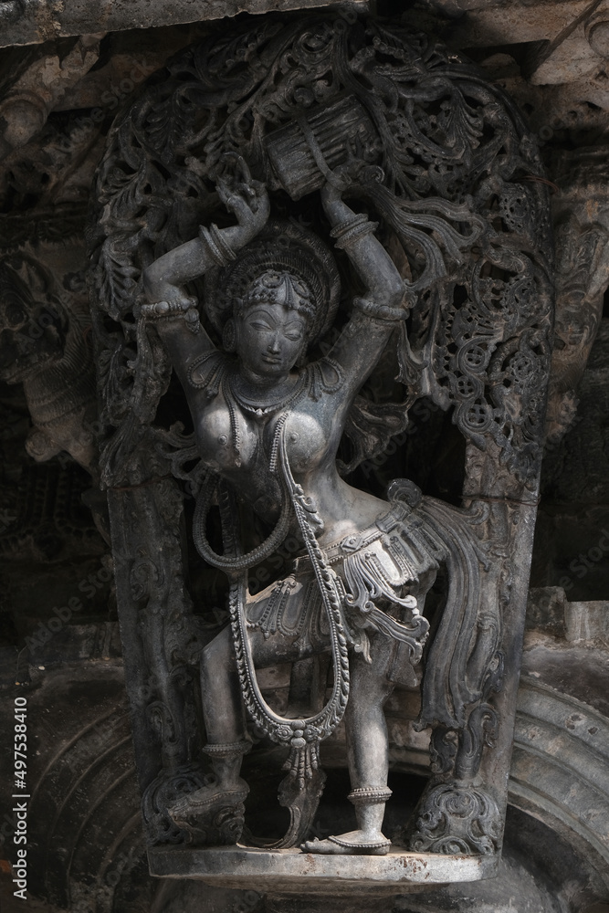 Stone Sculpture of Beautiful Female (Madanikas) with selective focus, 12th century Hindu temple, Ancient stone art and sculptures in each pillars, Chennakeshava Temple, Belur, Karnataka, India. Stone Sculpture of Beautiful Female (Madanikas) with selective focus, 12th century Hindu temple, Ancient stone art and sculptures in each pillars, Chennakeshava Temple, Belur, Karnataka, India.