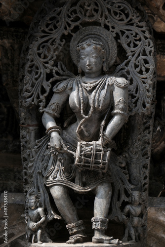 Stone Sculpture of Beautiful Female (Madanikas) with selective focus, 12th century Hindu temple, Ancient stone art and sculptures in each pillars, Chennakeshava Temple, Belur, Karnataka, India.