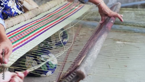 Close up of local asian woman making sedge mat organic Vietnamese product photo