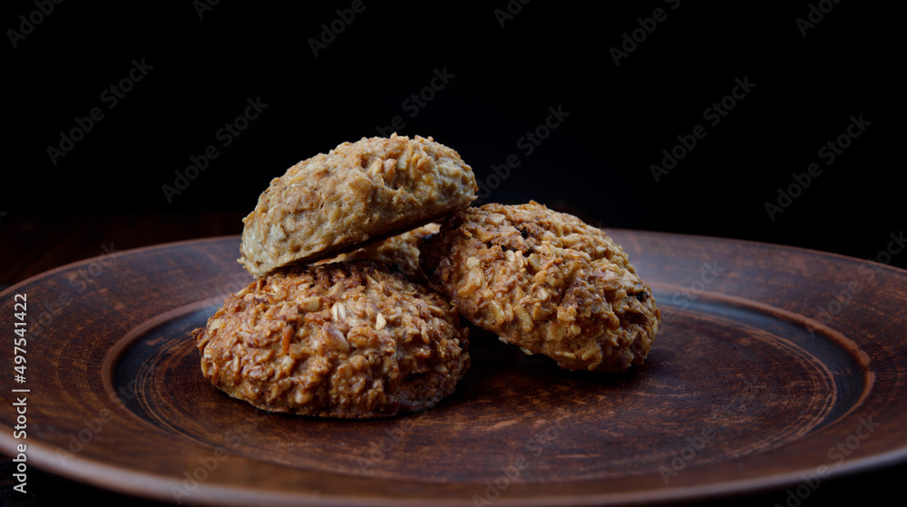 Oatmeal cookies lie on a clay plate. Rustic oatmeal cookies. Oatmeal cookies lie on a clay plate. Rustic oatmeal cookies.