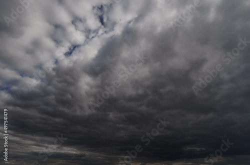 background of dark dramatic sky with stormy clouds before rain or snow, extreme weather