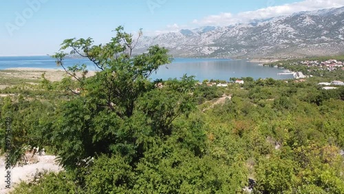 National Park Paklencia, Rovanjska Bay Village and Velebit Mountain - Aerial Drone View (Panning Up - Revealing) photo