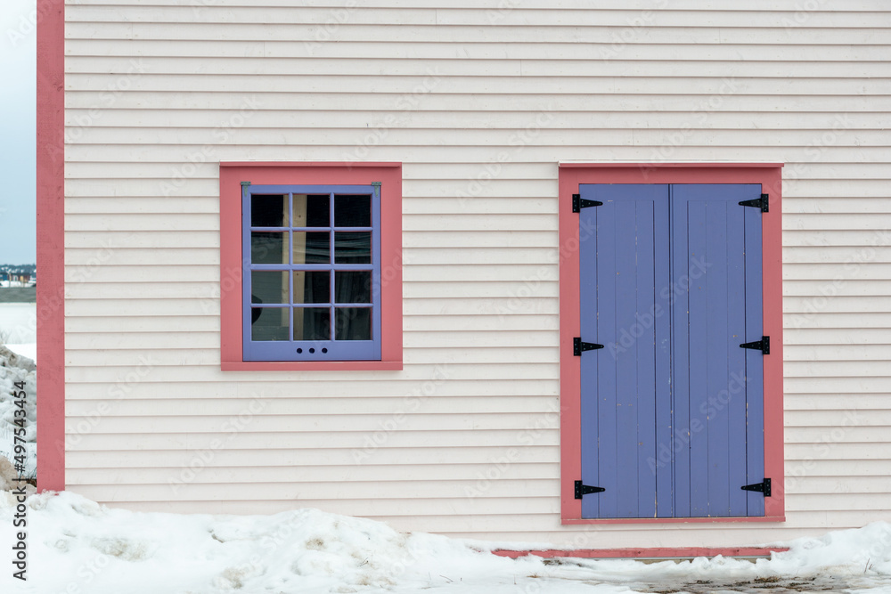 The Exterior Wall Of A White Wooden Cape Cod Clapboard Siding House With A  Purple Panel