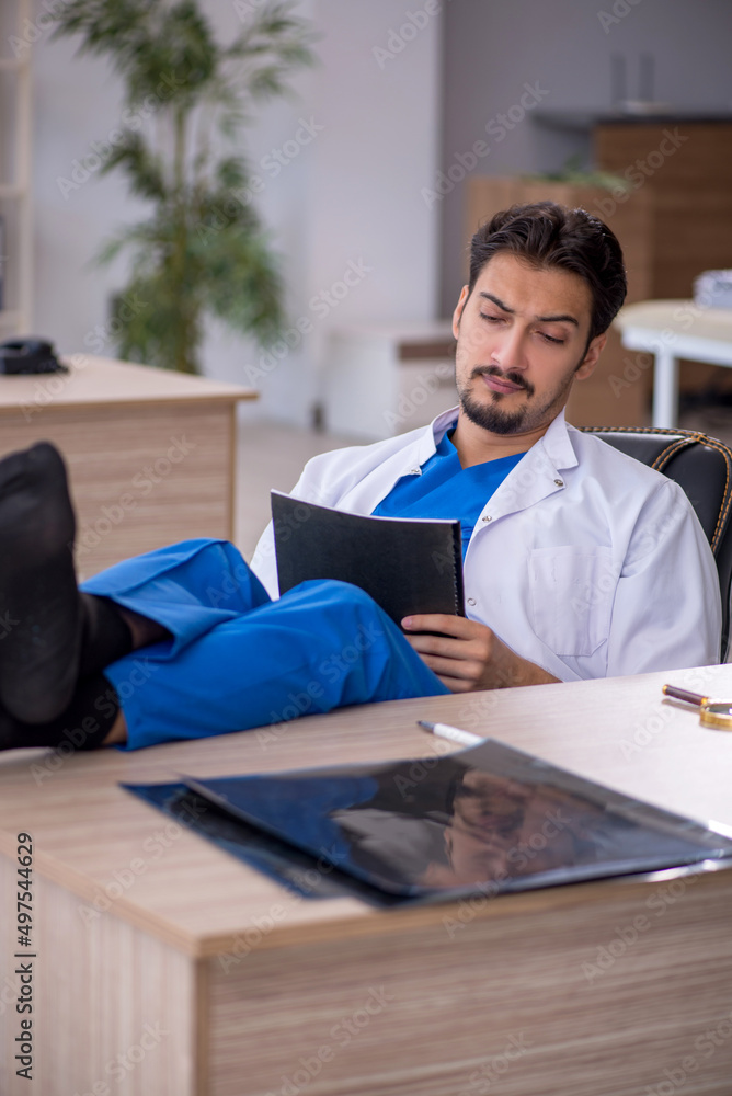 Young male doctor working in the clinic Young male doctor working in the clinic