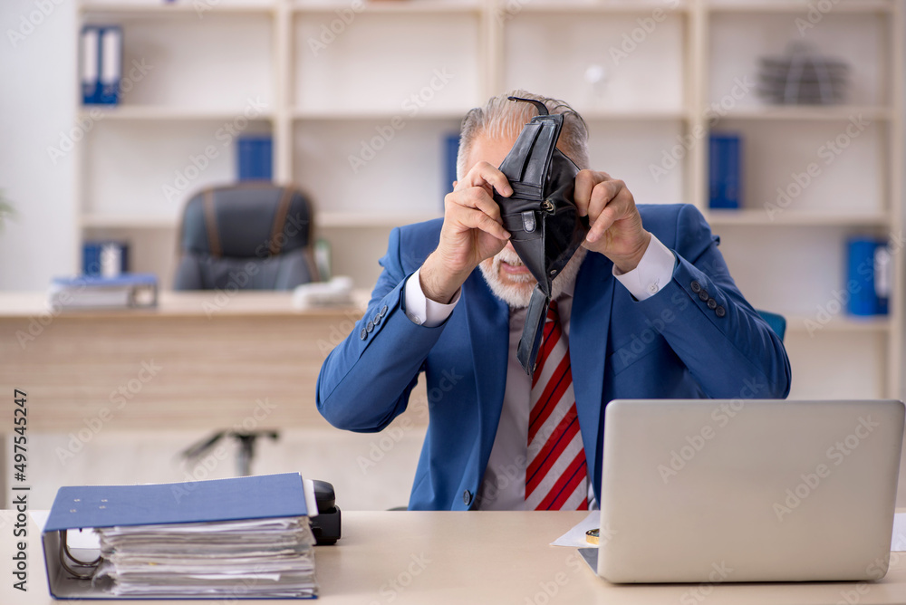 Old male employee in remuneration concept Old male employee in remuneration concept
