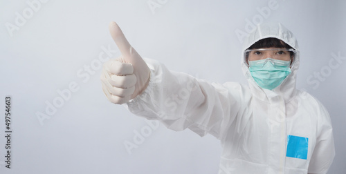 Doctor in PPE suit wearing white medical rubber gloves and clear goggles and green N95 face mask to protect pandemic Coronavirus. gesture make hand sign. Represent victory win over virus. Isolated