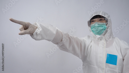 Vászonkép Doctor in PPE suit wearing white medical rubber gloves and clear goggles and green N95 face mask to protect pandemic Coronavirus