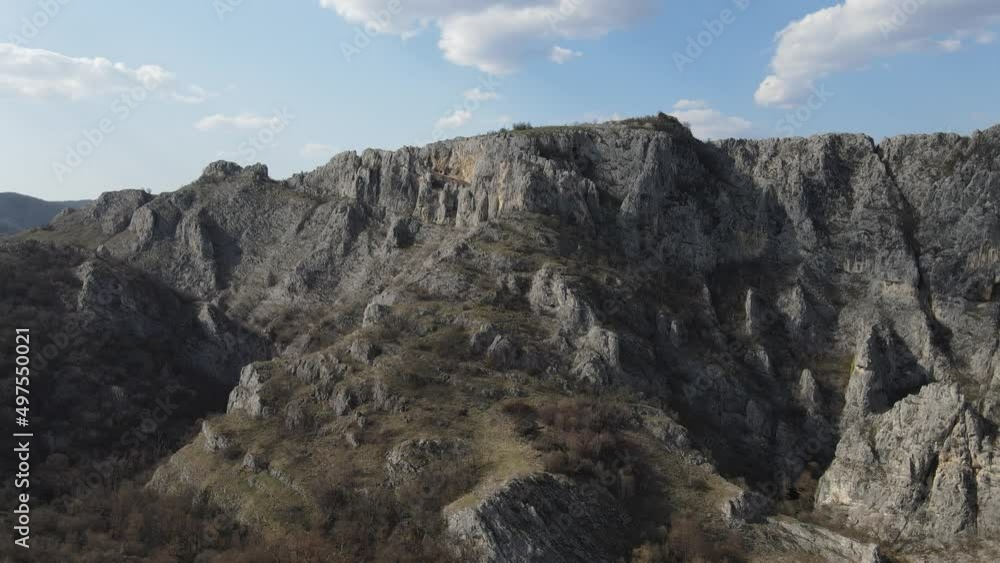 Aerial drone video over the hill mountain cliff with rocks of the Nisevac near Svrljig in Serbia in sunny day Aerial drone video over the hill mountain cliff with rocks of the Nisevac near Svrljig in Serbia in sunny day
