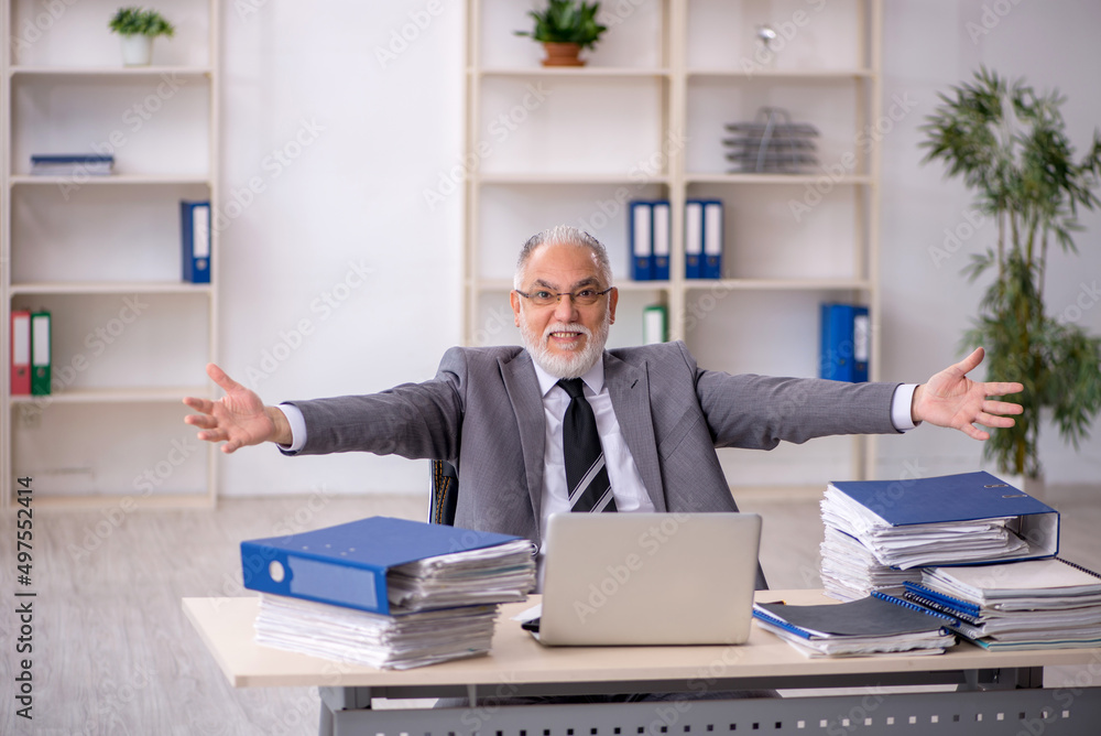 Old male employee and too much work in the office Old male employee and too much work in the office