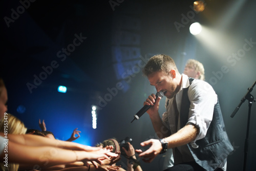 Playing to the adoring fans. Shot of a band playing at a music festival- This concert was created for the sole purpose of this photo shoot, featuring 300 models and 3 live bands. All people in this