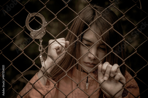 Portrait of women desperate to catch the iron prison,prisoner concept,thailand people,Hope to be free,If the violate the law would be arrested and jailed.