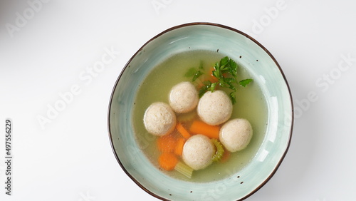 Jewish chicken broth with kneidlach (balls made with matzo meal)Matzo ball soup photo