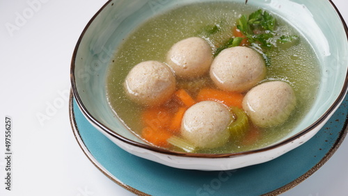 Jewish chicken broth with kneidlach (balls made with matzo meal)Matzo ball soup photo