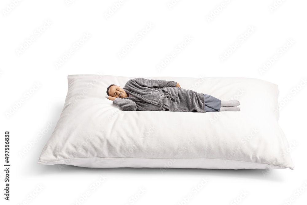 Mature man in a bathrobe sleeping on a giant pillow - obrazy, fototapety, plakaty 