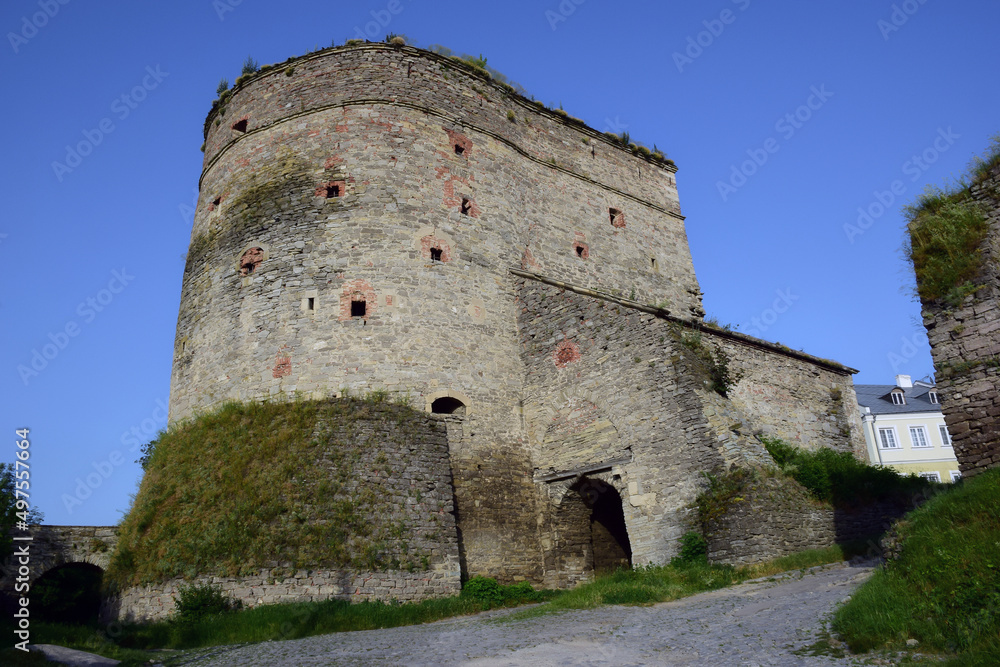 Tower of a medieval stone citadel with many loopholes