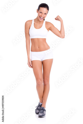 Hard as a rock. Studio shot of an attractive young woman flexing her biceps isolated on white.