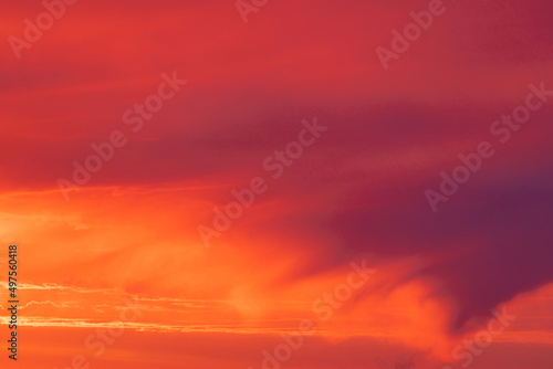 Vivid, bright and colorful background of red, orange and yellow morning or evening sky during sunrise or sunset © Майджи Владимир