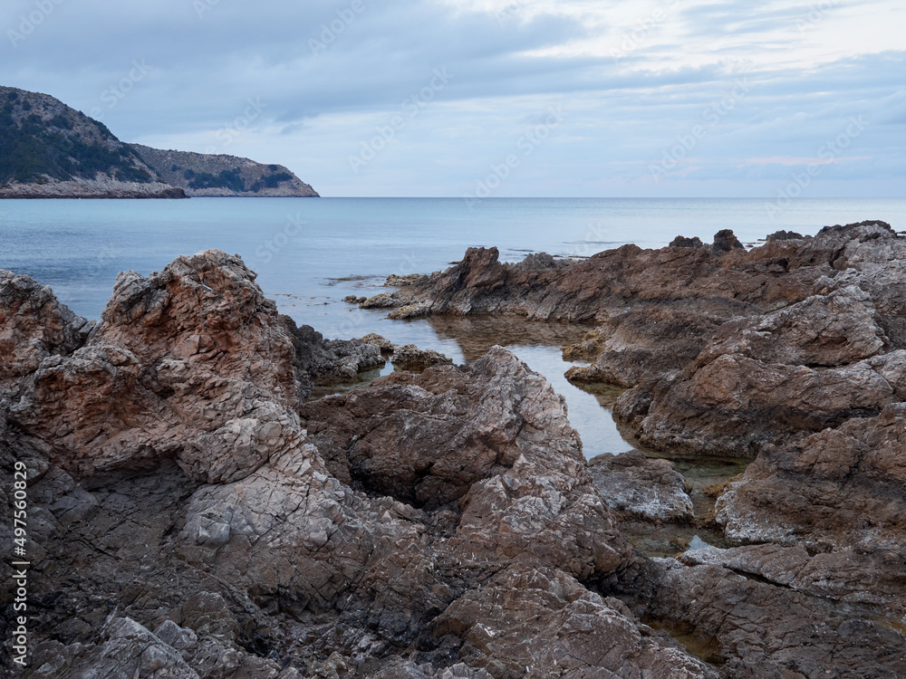 Rocks and turquoise water in Cala Agulla in Cala Ratjada at sunset. Majorca, Balearic Islands, Spain, Europe Rocks and turquoise water in Cala Agulla in Cala Ratjada at sunset. Majorca, Balearic Islands, Spain, Europe
