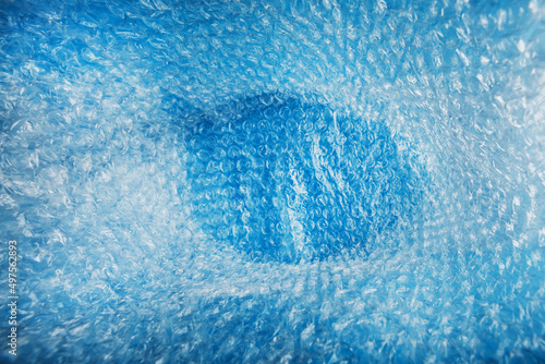 Inner space in a bag of packaging air-bubble film on a blue background in full screen