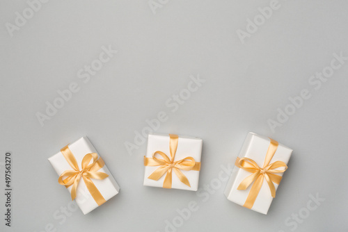 White gift boxes on color background, top view