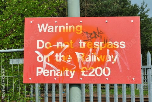 фотографія Old Red Warning Sign with Painted Graffiti