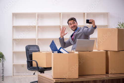 Young male employee in office relocation concept