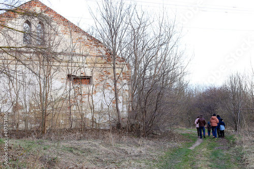 Family tour in the woods near the abandoned ruined architecture